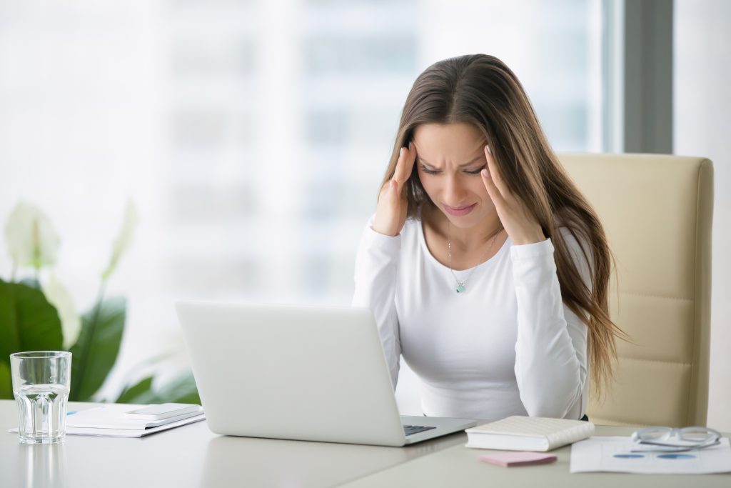 Young,Frustrated,Woman,Working,At,Office,Desk,In,Front,Of